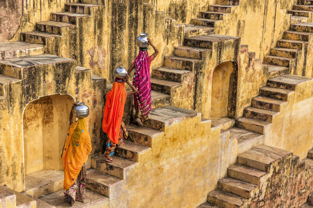 Indian women carrying water from stepwell near Jaipur